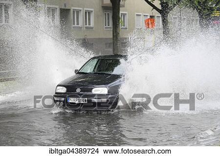 Rain, bad weather, car on flooded road, Ramersdorf, Munich, Upper Bavaria, Bavaria, Germany, Europe View Large Photo Image Picture - Rain, bad weather, car on flooded road, Ramersdorf, Munich, Upper Bavaria, Bavaria, Germany, Europe. Fotosearch