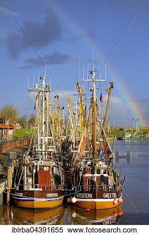 Rainbow behind shrimp boats, harbour, Greetsiel, North Sea, Lower Saxony, Germany, Europe View Large Photo Image Stock Photography - Rainbow behind shrimp boats, harbour, Greetsiel, North Sea, Lower Saxony, Germany, Europe. Fotosearch