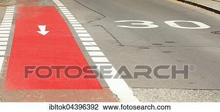 Stock Image - Red bicycle path, 30 speed marking on road, Kempten, Unterallgäu, Allgäu, Swabia, Bavaria, Germany, Europe. Fotosearch