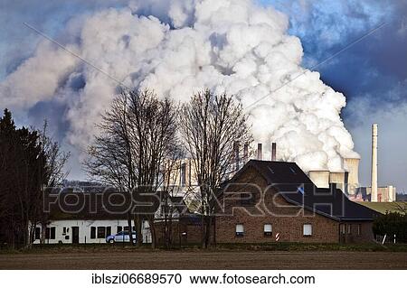Residential building at Rather Mühle in front of Neurath lignite-fired power plant, Grevenbroich, North Rhine-Westphalia, Germany, Europe View Large Photo Image Stock Image - Residential building at Rather Mühle in front of Neurath lignite-fired power plant, Grevenbroich, North Rhine-Westphalia, Germany, Europe. Fotosearch