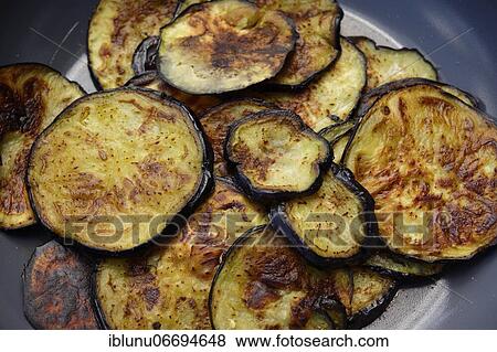 Roasted eggplant slices in frying pan, Bern, Switzerland, Europe View Large Photo Image Stock Photo - Roasted eggplant slices in frying pan, Bern, Switzerland, Europe. Fotosearch