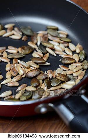 Roasted pumpkin seeds and sunflower seeds in pan, pumpkin seeds View Large Photo Image Stock Photo - Roasted pumpkin seeds and sunflower seeds in pan, pumpkin seeds. Fotosearch