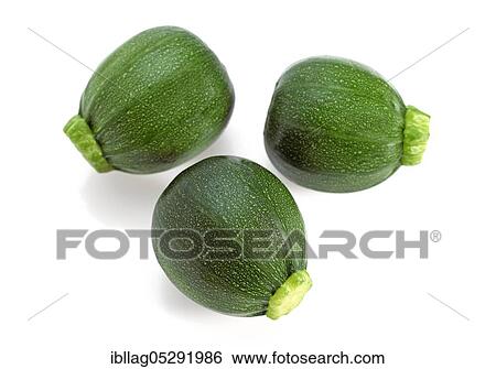 Stock Photograph - Round zucchini or courgettes, vegetables against white background. Fotosearch