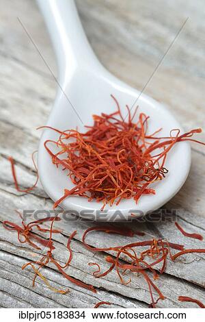Picture - Saffron crocus (Crocus sativus) threads in porcelain spoon. Fotosearch