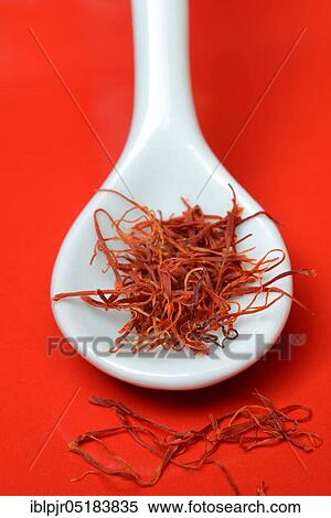 Stock Photography - Saffron crocus (Crocus sativus) threads in porcelain spoon. Fotosearch