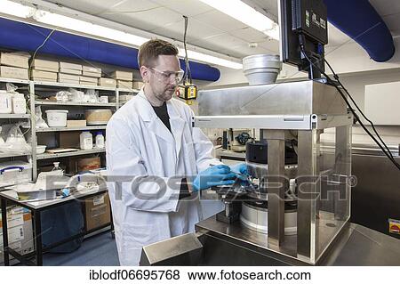 Scientists during their research work on a tablet press at the Institute for Pharmaceutical Technology and Biopharmacy at Heinrich-Heine-University Düsseldorf, North Rhine-Westphalia, Germany, Europe View Large Photo Image Stock Photo - Scientists during their research work on a tablet press at the Institute for Pharmaceutical Technology and Biopharmacy at Heinrich-Heine-University Düsseldorf, North Rhine-Westphalia, Germany, Europe. Fotosearch
