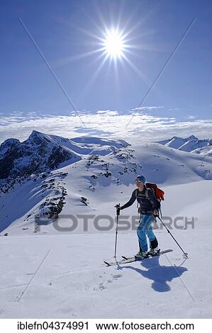 Ski tourer ascending Burstinden, snowy mountain landscape, Senja, Norway, Europe View Large Photo Image Stock Image - Ski tourer ascending Burstinden, snowy mountain landscape, Senja, Norway, Europe. Fotosearch