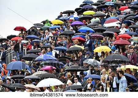 Spectators on platform with umbrellas in rain, Stuttgart Weissenhof, Stuttgart, Baden-Württemberg, Germany, Europe View Large Photo Image Picture - Spectators on platform with umbrellas in rain, Stuttgart Weissenhof, Stuttgart, Baden-Württemberg, Germany, Europe. Fotosearch