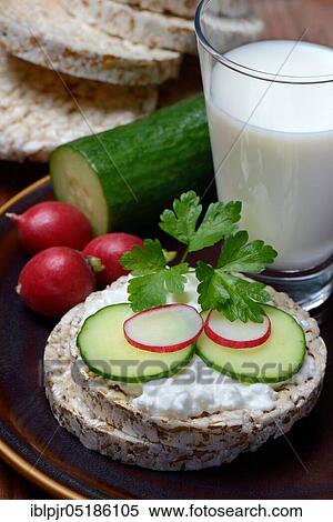 Spelt wafer topped with cream cheese, cucumber and radish, glass of milk, spelt wafers View Large Photo Image Stock Photography - Spelt wafer topped with cream cheese, cucumber and radish, glass of milk, spelt wafers. Fotosearch