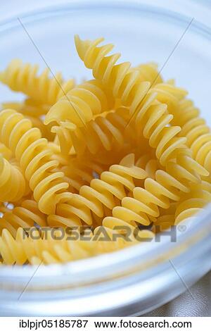 Spiral noodles in glass bowl, Fusilli, uncooked View Large Photo Image Stock Photo - Spiral noodles in glass bowl, Fusilli, uncooked. Fotosearch