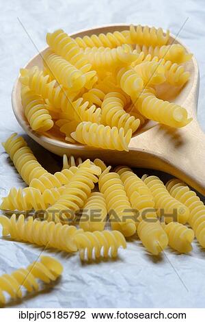 Spiral noodles in wooden ladle, Fusilli, uncooked View Large Photo Image Stock Image - Spiral noodles in wooden ladle, Fusilli, uncooked. Fotosearch