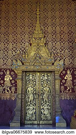 Stock Photo - Splendid entrance door with carved half reliefs and decorative ornaments, Wat Sibounheuang, Luang Prabang, Laos, Asia. Fotosearch