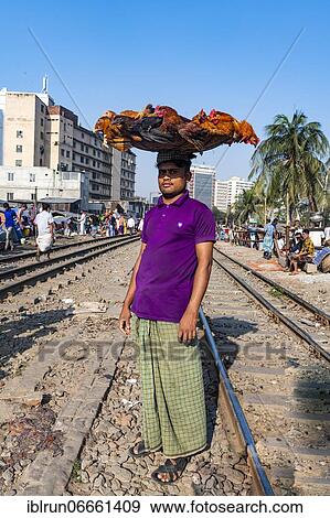 Street vendor on the railway tracks going through Kawran Bazar, Dhaka, Bangladesh, Asia View Large Photo Image Stock Photo - Street vendor on the railway tracks going through Kawran Bazar, Dhaka, Bangladesh, Asia. Fotosearch