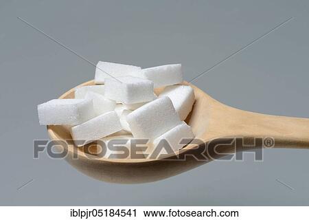 Stock Image - Sugar cubes in wooden spoon, sugar cube, sugar cube. Fotosearch