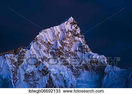 Stock Image - Sunset view from Kala Patthar on Nuptse west flank, 7861m, Sagarmatha National Park, Solu Khumbu, Nepal, Asia. Fotosearch