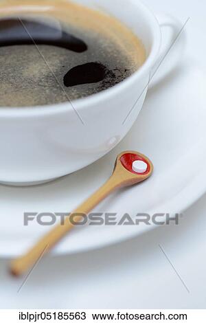 Stock Image - Sweetener tablet and coffee cup. Fotosearch