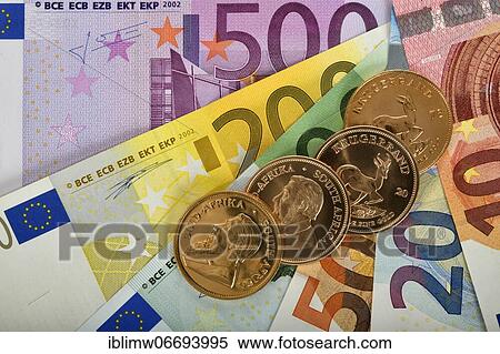 Symbol image price development gold price, physical gold coin 1 oz gold Kruger Rand obverse Paul Kruger and reverse Springbok antelope on EURO banknotes money compartments View Large Photo Image Stock Photography - Symbol image price development gold price, physical gold coin 1 oz gold Kruger Rand obverse Paul Kruger and reverse Springbok antelope on EURO banknotes money compartments. Fotosearch