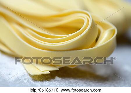 Tagliatelle, uncooked, pappardelle, pasta, ribbon noodles View Large Photo Image Stock Image - Tagliatelle, uncooked, pappardelle, pasta, ribbon noodles. Fotosearch