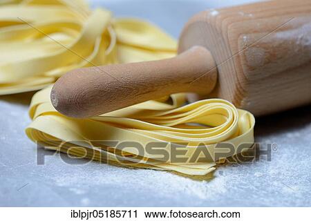 Tagliatelle, uncooked, pappardelle, pasta, ribbon noodles, rolling pin View Large Photo Image Stock Image - Tagliatelle, uncooked, pappardelle, pasta, ribbon noodles, rolling pin. Fotosearch