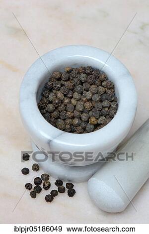 Stock Photo - Tellicherry pepper in mortar. Fotosearch
