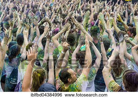 Thousands of young women and man are raising their arms at the colorful Holi festival, Dresden, Saxony, Germany, Europe View Large Photo Image Stock Photograph - Thousands of young women and man are raising their arms at the colorful Holi festival, Dresden, Saxony, Germany, Europe. Fotosearch