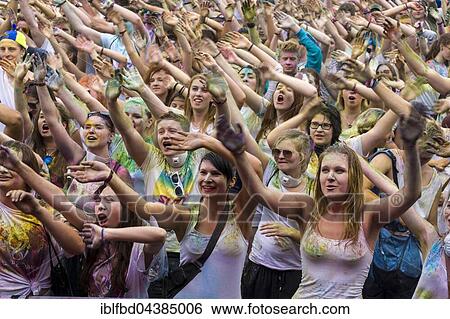 Thousands of young women and man are raising their arms at the colorful Holi festival, Dresden, Saxony, Germany, Europe View Large Photo Image Stock Photograph - Thousands of young women and man are raising their arms at the colorful Holi festival, Dresden, Saxony, Germany, Europe. Fotosearch