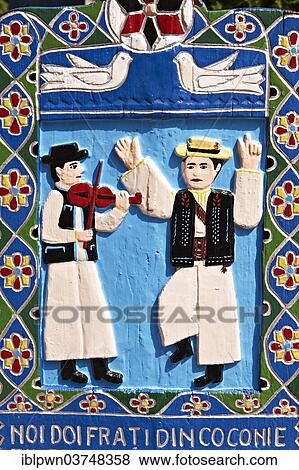 Stock Photo - Tombstone, a fiddler and a man dancing in traditional clothes, The Merry Cemetery, Cimitirul Vesel, Săpânța, Maramares, Northern Transylvania, Romania, Europe. Fotosearch
