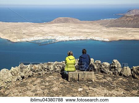 Tourists at Mirador del Rio, viewpoint, Graciosa Island and El Rio channel, Chinijo archipelago, Lanzarote, Canary Islands, Spain, Europe View Large Photo Image Stock Photo - Tourists at Mirador del Rio, viewpoint, Graciosa Island and El Rio channel, Chinijo archipelago, Lanzarote, Canary Islands, Spain, Europe. Fotosearch