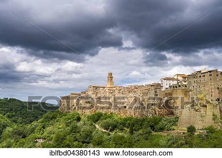 Town on hill and cloudy sky, Pitigliano, Tuscany, Italy, Europe View Large Photo Image Stock Image - Town on hill and cloudy sky, Pitigliano, Tuscany, Italy, Europe. Fotosearch
