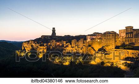 Town on hill, illuminated at dusk, Pitigliano, Tuscany, Italy, Europe View Large Photo Image Stock Photograph - Town on hill, illuminated at dusk, Pitigliano, Tuscany, Italy, Europe. Fotosearch
