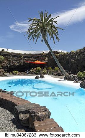 Tropical garden with swimming pool, lava cave Jameos del Agua, by Cesar Manrique, Lanzarote, Canary Islands, Spain, Europe View Large Photo Image Stock Image - Tropical garden with swimming pool, lava cave Jameos del Agua, by Cesar Manrique, Lanzarote, Canary Islands, Spain, Europe. Fotosearch