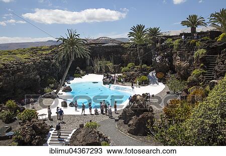 Tropical garden with swimming pool, lava cave Jameos del Agua, by Cesar Manrique, Lanzarote, Canary Islands, Spain, Europe View Large Photo Image Stock Image - Tropical garden with swimming pool, lava cave Jameos del Agua, by Cesar Manrique, Lanzarote, Canary Islands, Spain, Europe. Fotosearch