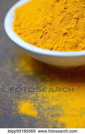 Stock Photo - Turmericpowder ( Curcuma longa) in bowl. Fotosearch