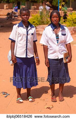 Stock Photograph - Two African schoolgirls in school uniform, Bobo-Dioulasso, Burkina Faso, Africa. Fotosearch
