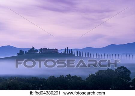 Typical green Tuscan landscape in Bagno Vignoni, Val d’Orcia with a farm on a hill, fields, cypresses, trees and morning fog before sunrise, San Quirico d’Orcia, Tuscany, Italy, Europe View Large Photo Image Stock Image - Typical green Tuscan landscape in Bagno Vignoni, Val d’Orcia with a farm on a hill, fields, cypresses, trees and morning fog before sunrise, San Quirico d’Orcia, Tuscany, Italy, Europe. Fotosearch