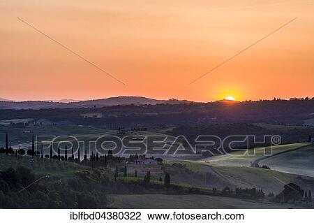 Typical green Tuscan landscape in Val d’Orcia with a farm on a hill, fields, cypresses, trees and morning fog at sunrise, San Quirico d’Orcia, Tuscany, Italy, Europe View Large Photo Image Stock Image - Typical green Tuscan landscape in Val d’Orcia with a farm on a hill, fields, cypresses, trees and morning fog at sunrise, San Quirico d’Orcia, Tuscany, Italy, Europe. Fotosearch