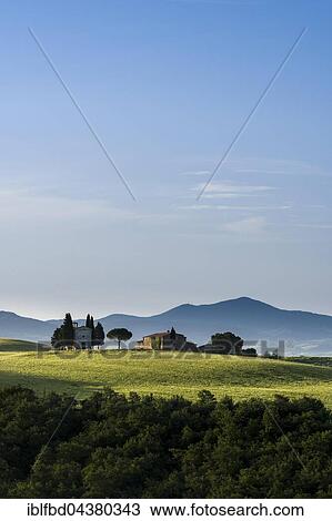 Typical green Tuscan landscape in Val d’Orcia with farm and chapel on hill, fields, cypresses, trees and blue, cloudy sky, San Quirico d’Orcia, Tuscany, Italy, Europe View Large Photo Image Stock Image - Typical green Tuscan landscape in Val d’Orcia with farm and chapel on hill, fields, cypresses, trees and blue, cloudy sky, San Quirico d’Orcia, Tuscany, Italy, Europe. Fotosearch