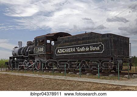 Stock Image - Used for transport of sugar cane and slaves, old locomotive and tender of the American Locomotive Company, series 1589, built in 1926, inscription Azucarera Grito de Yara, Camagüey, Camagüey Province, Cuba, Central America. Fotosearch