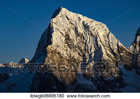Stock Image - View in the evening light from Renjo La Pass 5417 m to the east to Cholatse, 6440 m, Khumbu Himal, Himalaya, Nepal, Asia. Fotosearch