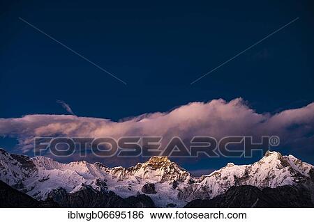 Stock Photograph - View in the evening light from Renjo La Pass 5417 m to the east on Himalaya with Gyachung Kang, 7952 m, and Hungchi, 7036 m, Khumbu Himal, Himalaya, Nepal, Asia. Fotosearch