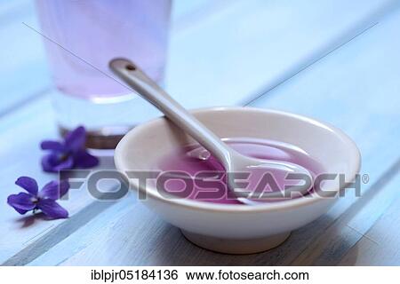 Violet syrup in bowl and glass, violet flowers View Large Photo Image Stock Photograph - Violet syrup in bowl and glass, violet flowers. Fotosearch