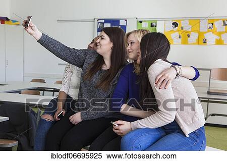 Vocational school students with their smartphones during break at the Elly-Heuss-Knapp-Schule, a vocational college of the city of Düsseldorf, North Rhine-Westphalia, Germany, Europe View Large Photo Image Stock Photography - Vocational school students with their smartphones during break at the Elly-Heuss-Knapp-Schule, a vocational college of the city of Düsseldorf, North Rhine-Westphalia, Germany, Europe. Fotosearch