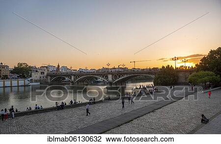 Waterfront Muelle de la sal at the river Rio Guadalquivir with bridge Puente de Triana, sunset, Sevilla, Andalusia, Spain, Europe View Large Photo Image Stock Image - Waterfront Muelle de la sal at the river Rio Guadalquivir with bridge Puente de Triana, sunset, Sevilla, Andalusia, Spain, Europe. Fotosearch