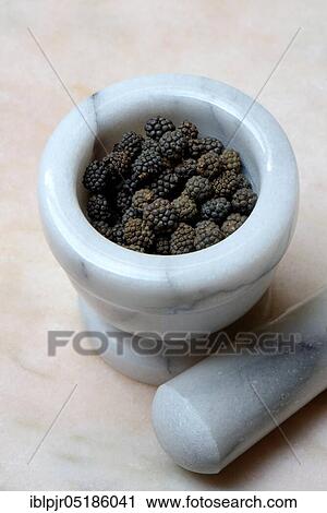 Stock Image - Wild Assam pepper in mortar, Assam, India, Asia. Fotosearch