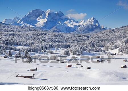 Stock Photograph - Winterly hummock meadows with Zugspitze group in the Wetterstein mountains, Krün, Werdenfelser Land, Upper Bavaria, Bavaria, Germany, Europe. Fotosearch