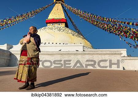 Woman praying in front of Boudhanath stupa, Boudhanath, Kathmandu, Bagmati Zone, Nepal, Asia View Large Photo Image Stock Image - Woman praying in front of Boudhanath stupa, Boudhanath, Kathmandu, Bagmati Zone, Nepal, Asia. Fotosearch