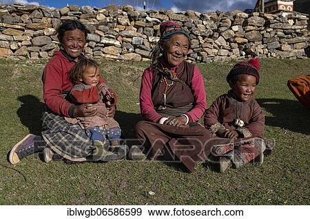 Stock Photo - Women and children sitting in the evening sun in a meadow, Shey Gompa, Dolpo, Nepal, Asia. Fotosearch