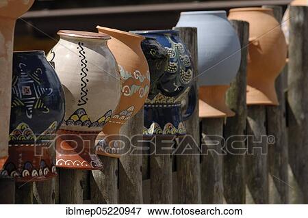 Wooden fence with painted clay jugs View Large Photo Image Stock Photo - Wooden fence with painted clay jugs. Fotosearch