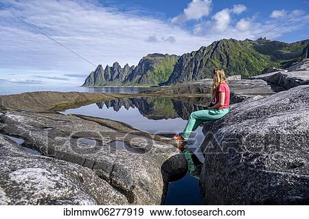 Young woman at tide pool, rocky coast of Tungeneset, rocky peak Devil's Teeth, devil's teeth, Okshornan, Steinfjorden, Senja Island, Troms, Norway, Europe View Large Photo Image Stock Photo - Young woman at tide pool, rocky coast of Tungeneset, rocky peak Devil's Teeth, devil's teeth, Okshornan, Steinfjorden, Senja Island, Troms, Norway, Europe. Fotosearch