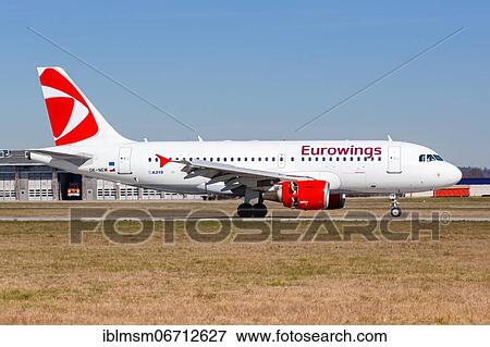 Stock Photo - A Eurowings Airbus A319 with registration OK-NEM lands at Stuttgart Airport, Germany, Europe. Fotosearch